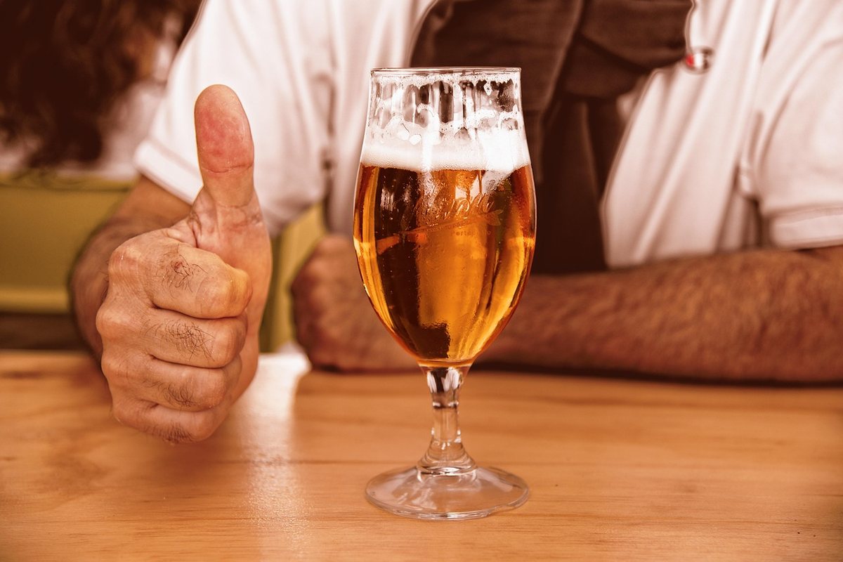 A glass of whisky poured neat on the bar