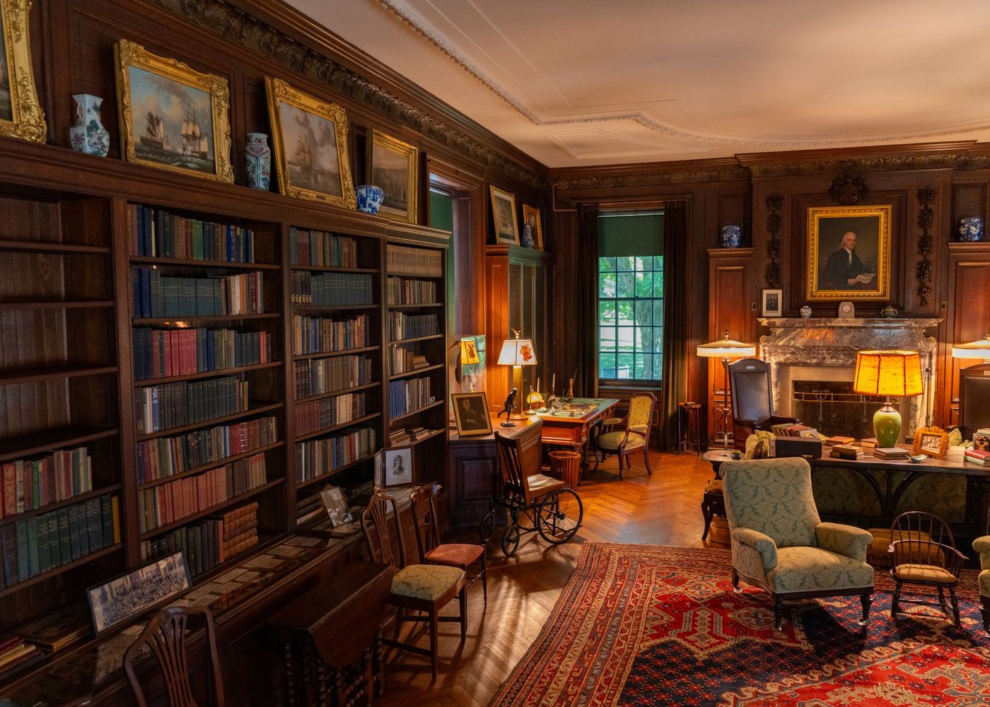 The drawing room at White Heath with a fireplace and bookshelves