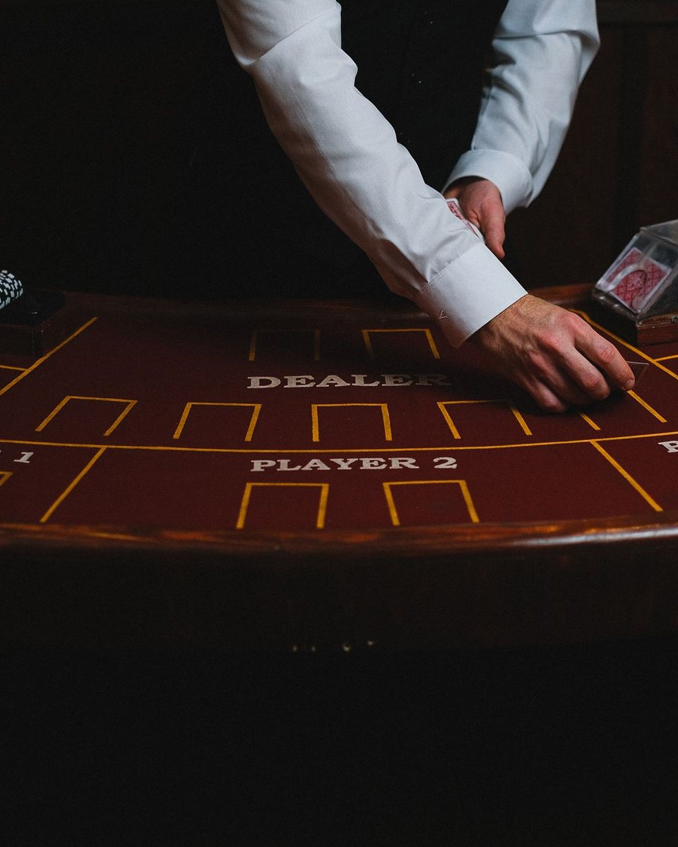 A dealer's hands at a table in the Signal Room