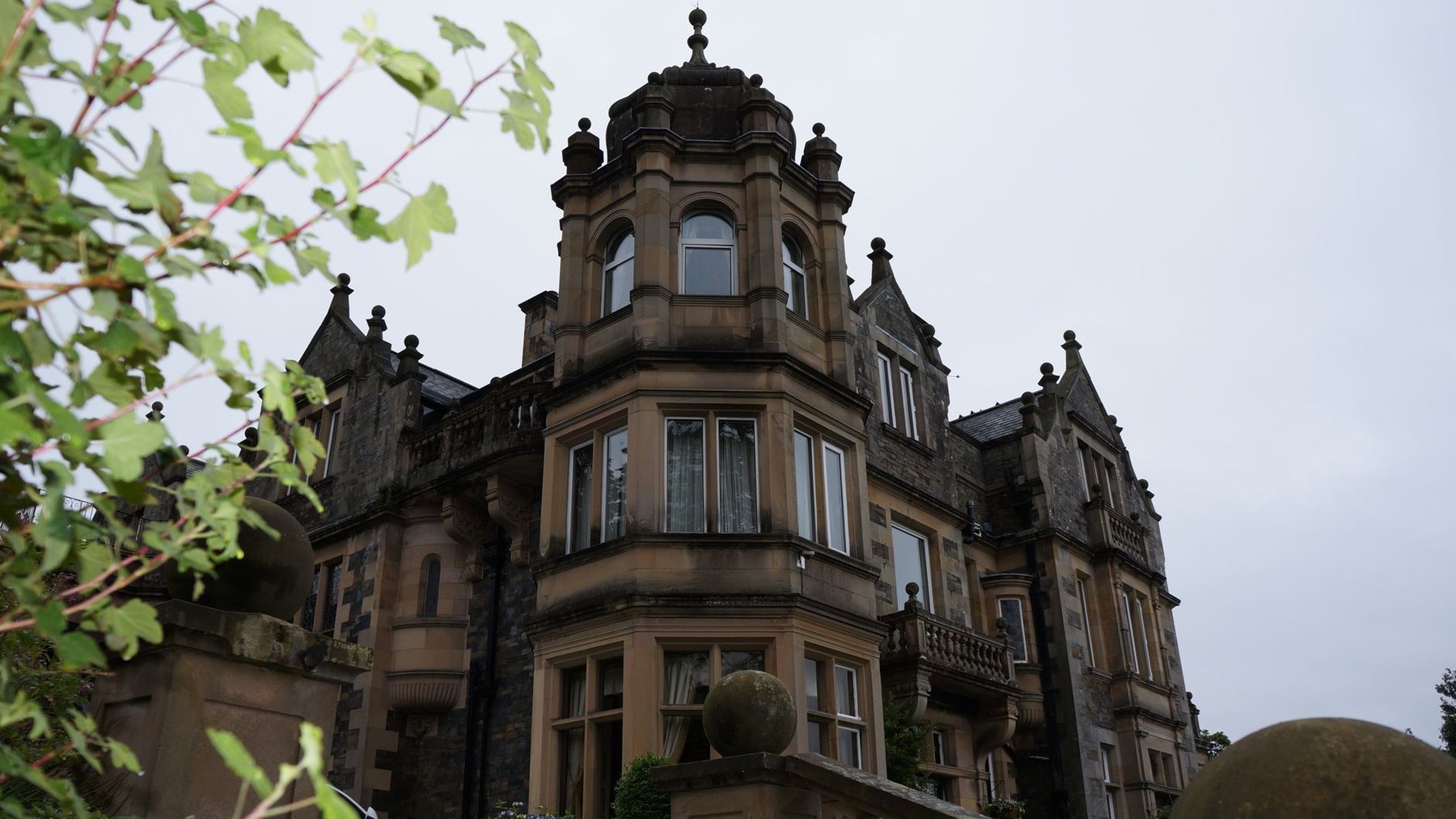 The stone facade of White Heath on Royal Terrace at dusk, windows lit