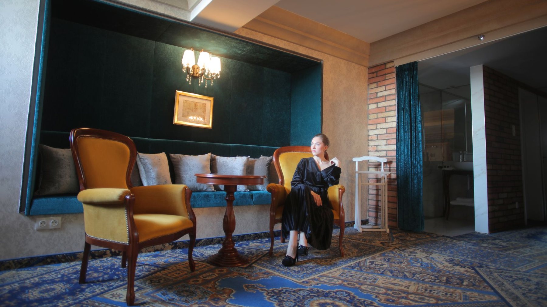 A quiet corner of the lounge at White Heath with an armchair and a lamp